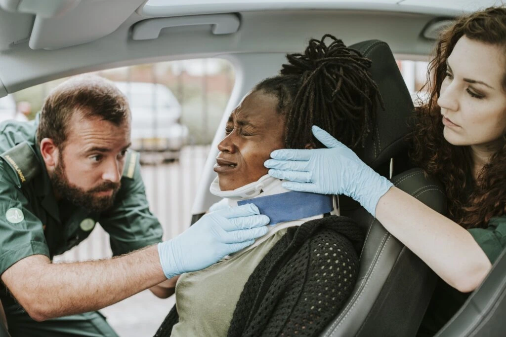 medics helping with car accident injuries